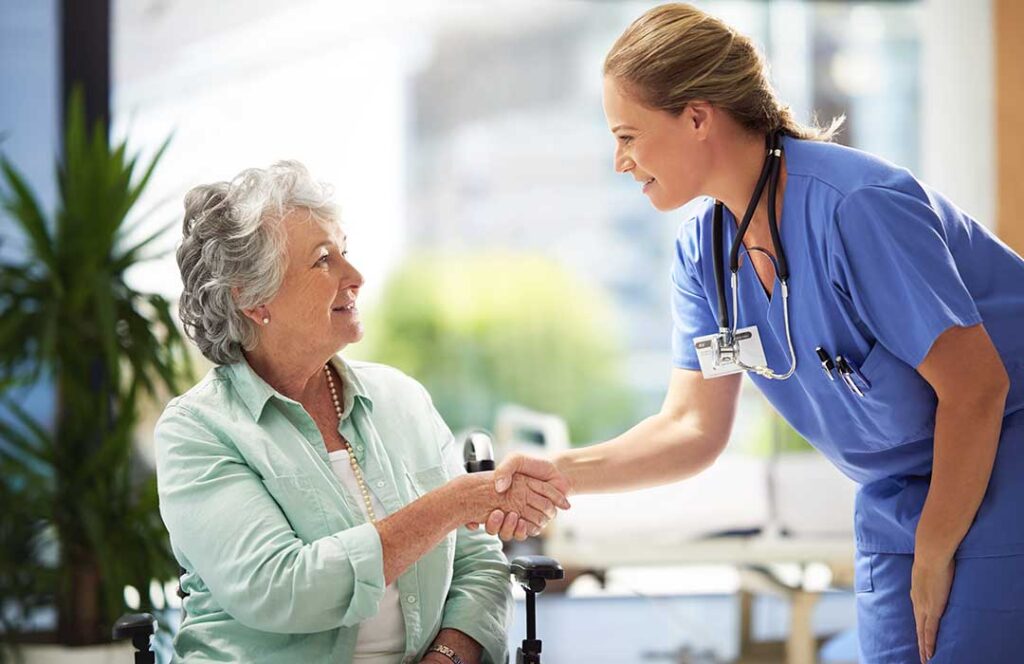 Older adult and family member reviewing a daily care checklist at a kitchen table.