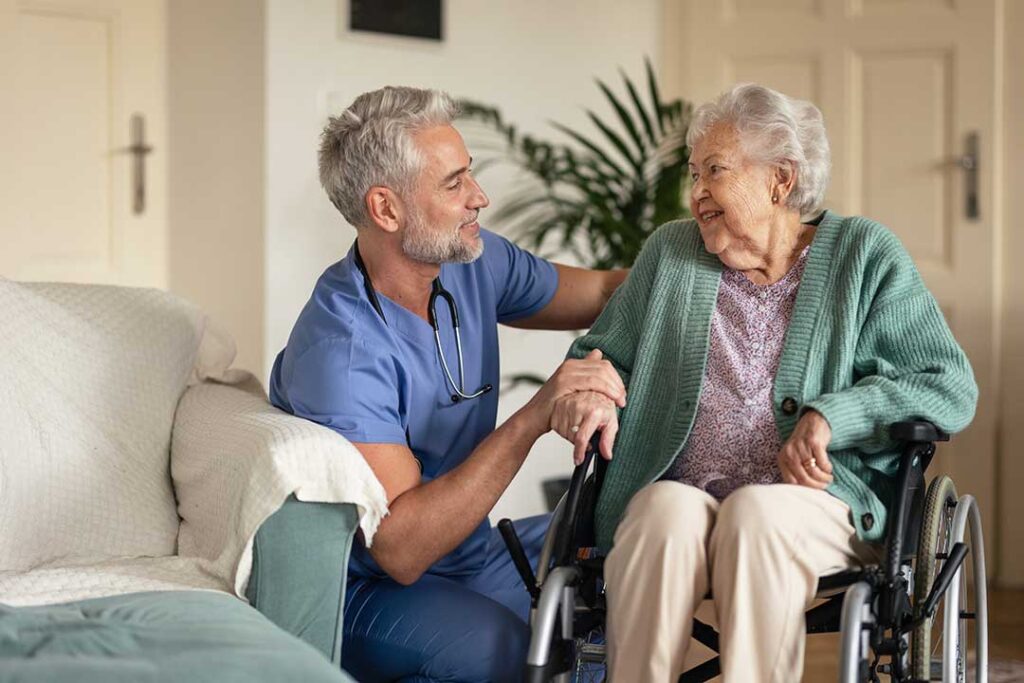 Family members discuss care options with an older adult at a table beside a walker and medication list.